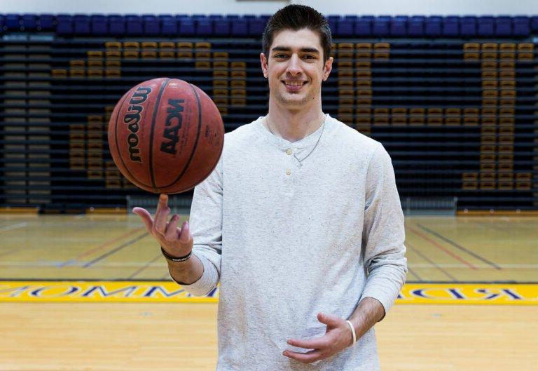 Caleb Spoon-Mathematics Major spinning basketball on the court